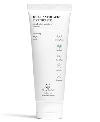 Brilliant Black® fluoride-free activated charcoal whitening toothpaste by Terra & Co. in a sleek tube with black and white packaging.