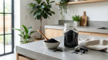 Activated charcoal powder in a glass jar